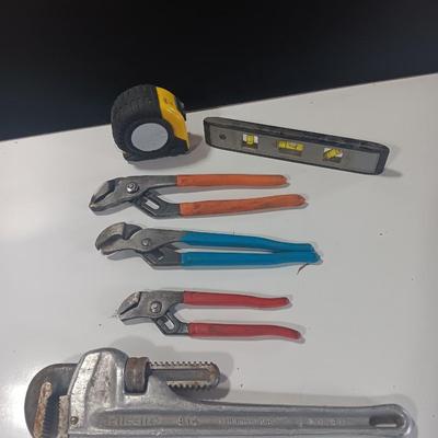 Assortment of piers - Rigid pipe wrench - tape measure and small level