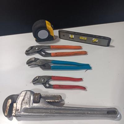 Assortment of piers - Rigid pipe wrench - tape measure and small level