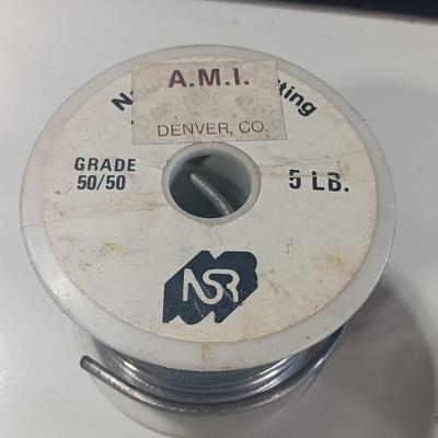 Rolls of Solder with Soldering Iron