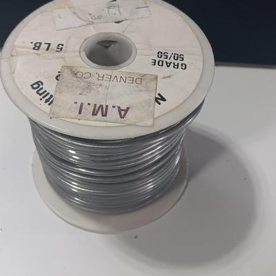 Rolls of Solder with Soldering Iron