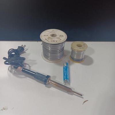 Rolls of Solder with Soldering Iron