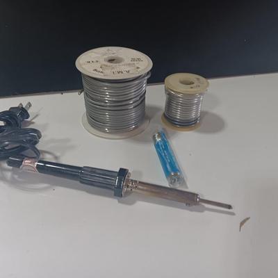Rolls of Solder with Soldering Iron