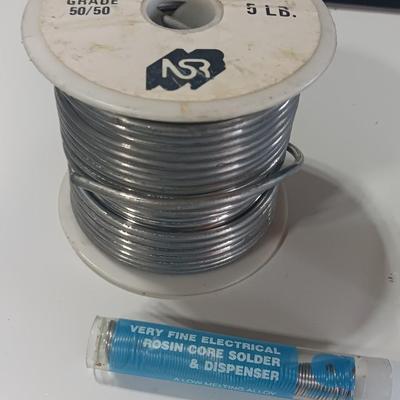 Rolls of Solder with Soldering Iron