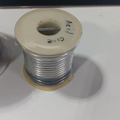 Rolls of Solder with Soldering Iron