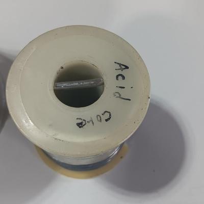 Rolls of Solder with Soldering Iron