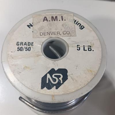 Rolls of Solder with Soldering Iron
