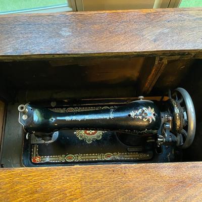 1900’s Singer Red Eye treadle sewing machine in tiger oak cabinet