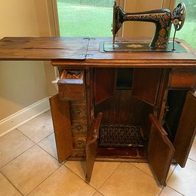 1900’s Singer Red Eye treadle sewing machine in tiger oak cabinet