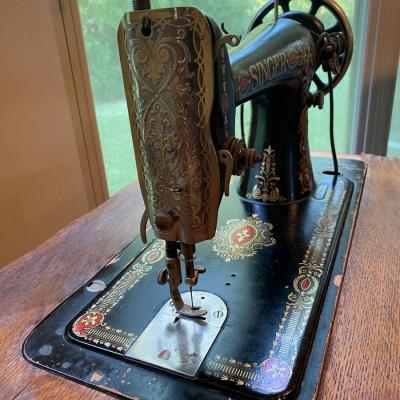 1900’s Singer Red Eye treadle sewing machine in tiger oak cabinet