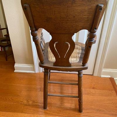 Antique solid wood highchair with cane seat