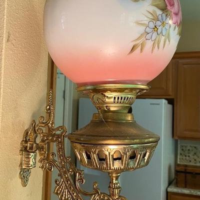 Antique wall-mounted oil lamp