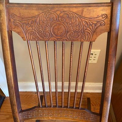 Antique wooden rocking chair with leather seat