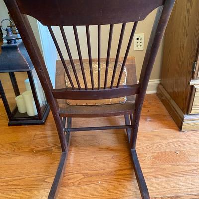Antique wooden rocking chair with leather seat