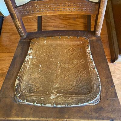 Antique wooden rocking chair with leather seat