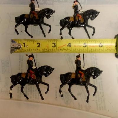 LOT 107 FOUR EARLY METAL HORSE SOLDIERS