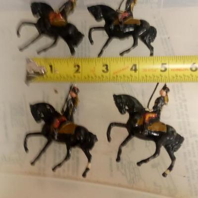 LOT 107 FOUR EARLY METAL HORSE SOLDIERS