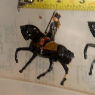 LOT 107 FOUR EARLY METAL HORSE SOLDIERS