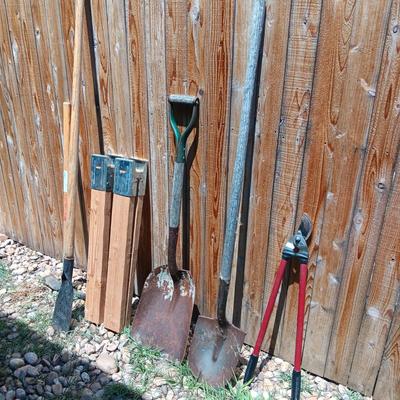 NICE PICK AXE, SAWHORSE LEGS, SPUD BAR, SHOVELS AND LOPERS