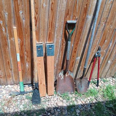 NICE PICK AXE, SAWHORSE LEGS, SPUD BAR, SHOVELS AND LOPERS