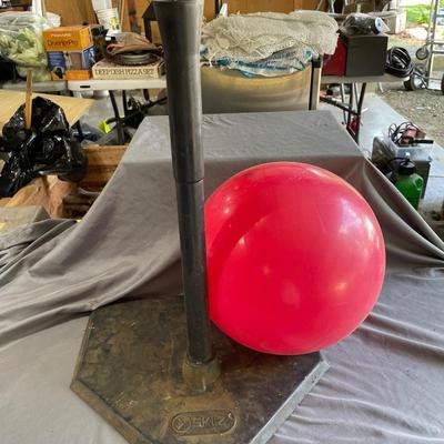 Practice tee and red ball