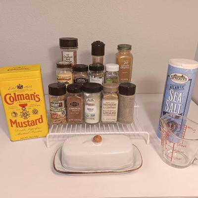 Assortment of lightly used kitchen spices with spice organizer - pottery butter dish - and Pyrex measuring cup