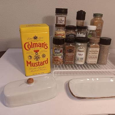 Assortment of lightly used kitchen spices with spice organizer - pottery butter dish - and Pyrex measuring cup