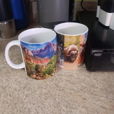 KEURIG SINGLE CUP COFFEE MAKER, PODS W/HOLDER, MUGS AND THERMOS