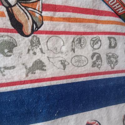 TWIN SIZE NFL FOOTBALL BLANKET AND JOHN ELWAY ON A BOX OF SEALED WHEATIES CEREAL
