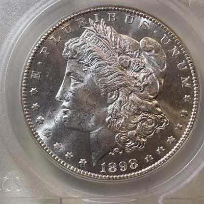 SEGS CERTIFIED 1898-O MS63 PROOF LIKE MORGAN SILVER DOLLAR AS PICTURED. SCARCE "O" FULL STRIKE COIN.