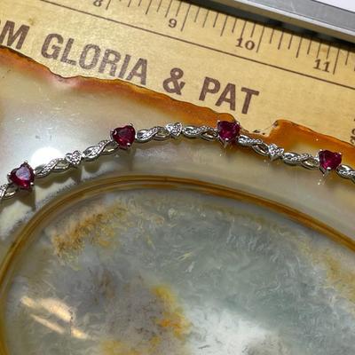 Sterling Silver .925 Dainty Heart Shaped Red Stones Bracelet 7-1/2" Long in VG Condition.