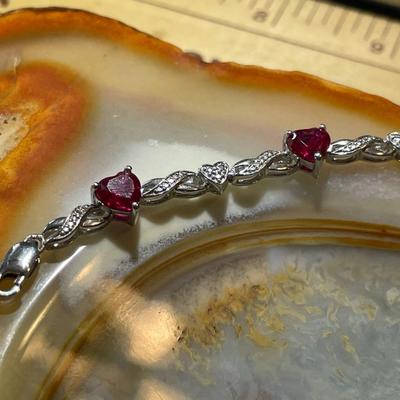 Sterling Silver .925 Dainty Heart Shaped Red Stones Bracelet 7-1/2" Long in VG Condition.