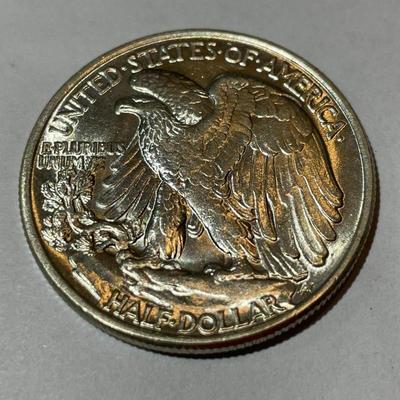 1945-P UNCIRCULATED CONDITION WALKING LIBERTY HALF DOLLAR AS PICTURED.