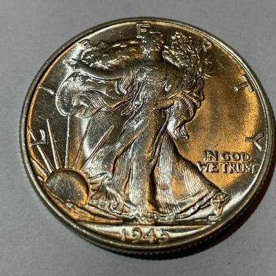 1945-P UNCIRCULATED CONDITION WALKING LIBERTY HALF DOLLAR AS PICTURED.