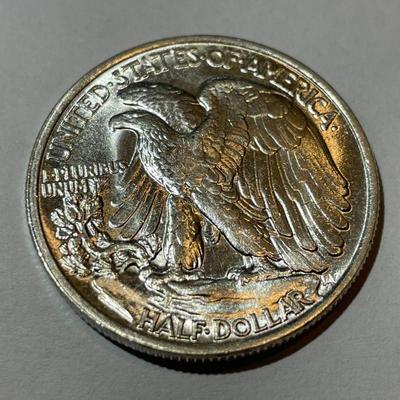 1943-P UNCIRCULATED CONDITION WALKING LIBERTY HALF DOLLAR AS PICTURED.