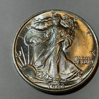 1943-P UNCIRCULATED CONDITION WALKING LIBERTY HALF DOLLAR AS PICTURED.