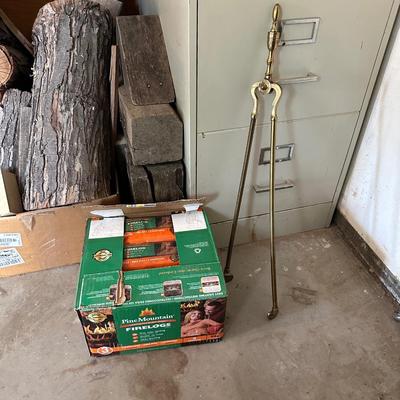 A CASE OF FIRE LOGS AND BRASS LOG TONGS