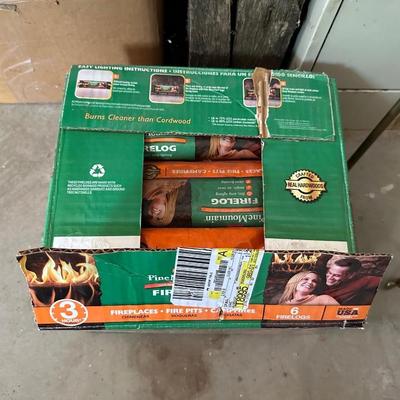 A CASE OF FIRE LOGS AND BRASS LOG TONGS