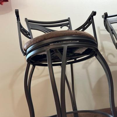 2 IRON SWIVEL BAR STOOLS WITH RAWHIDE CUSHIONED SEATS