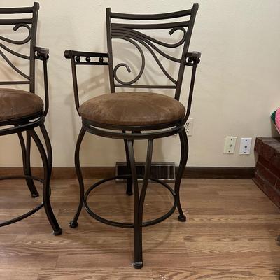 2 IRON SWIVEL BAR STOOLS WITH RAWHIDE CUSHIONED SEATS