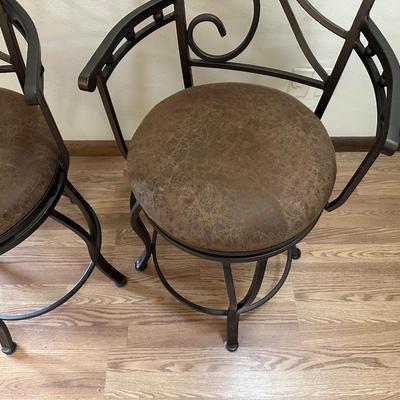 2 IRON SWIVEL BAR STOOLS WITH RAWHIDE CUSHIONED SEATS