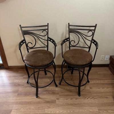 2 IRON SWIVEL BAR STOOLS WITH RAWHIDE CUSHIONED SEATS
