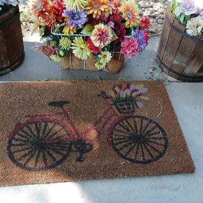 2 PLASTIC WHISKEY BARREL LIKE PLANTERS, BASKET OF FAUX FLOWERS AND DOOR MAT