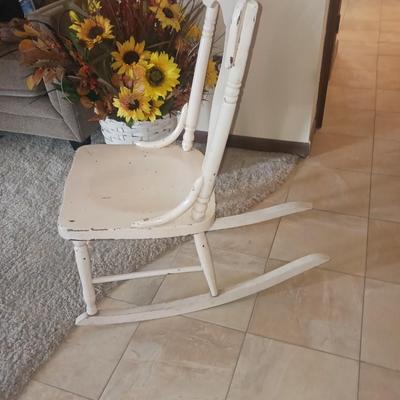 ANTIQUE ROCKING CHAIR AND FAUX FLOWERS IN A VASE