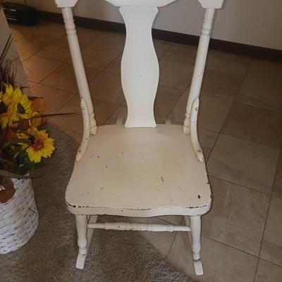 ANTIQUE ROCKING CHAIR AND FAUX FLOWERS IN A VASE