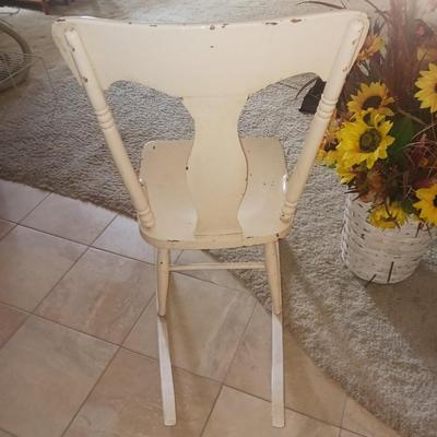 ANTIQUE ROCKING CHAIR AND FAUX FLOWERS IN A VASE