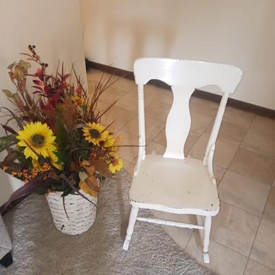 ANTIQUE ROCKING CHAIR AND FAUX FLOWERS IN A VASE