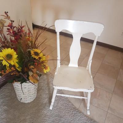 ANTIQUE ROCKING CHAIR AND FAUX FLOWERS IN A VASE