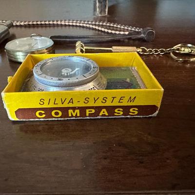 COMPASSES, BOLO TIE, BELT BUCKLE, HAND WARMER AND MORE