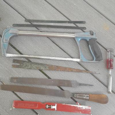 Hack saw with an assortment of files - one is nicely curved, and other small tools