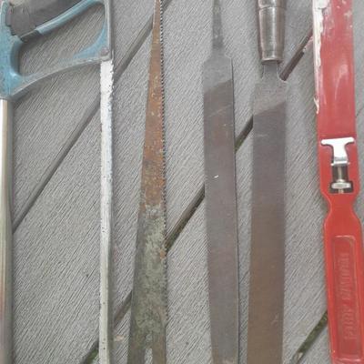 Hack saw with an assortment of files - one is nicely curved, and other small tools
